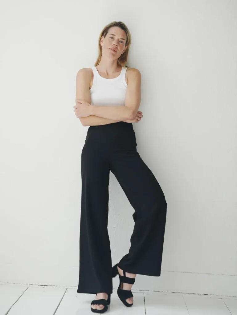 Woman in white tank and black wide-leg pants