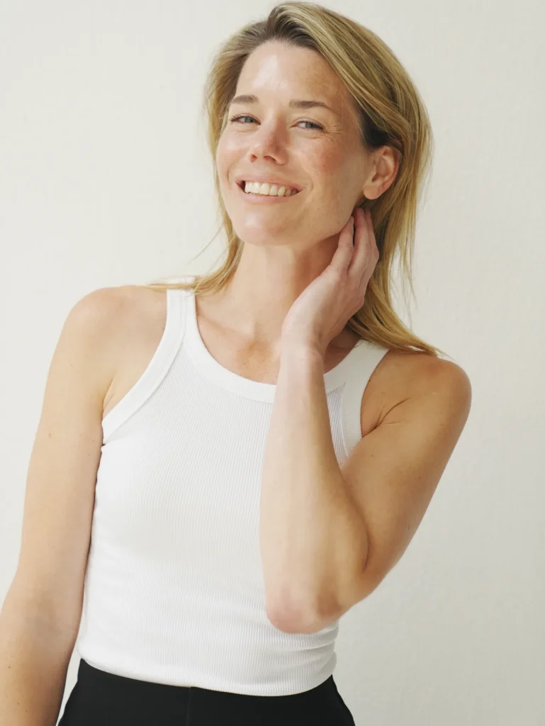 Smiling woman in white tank top portrait