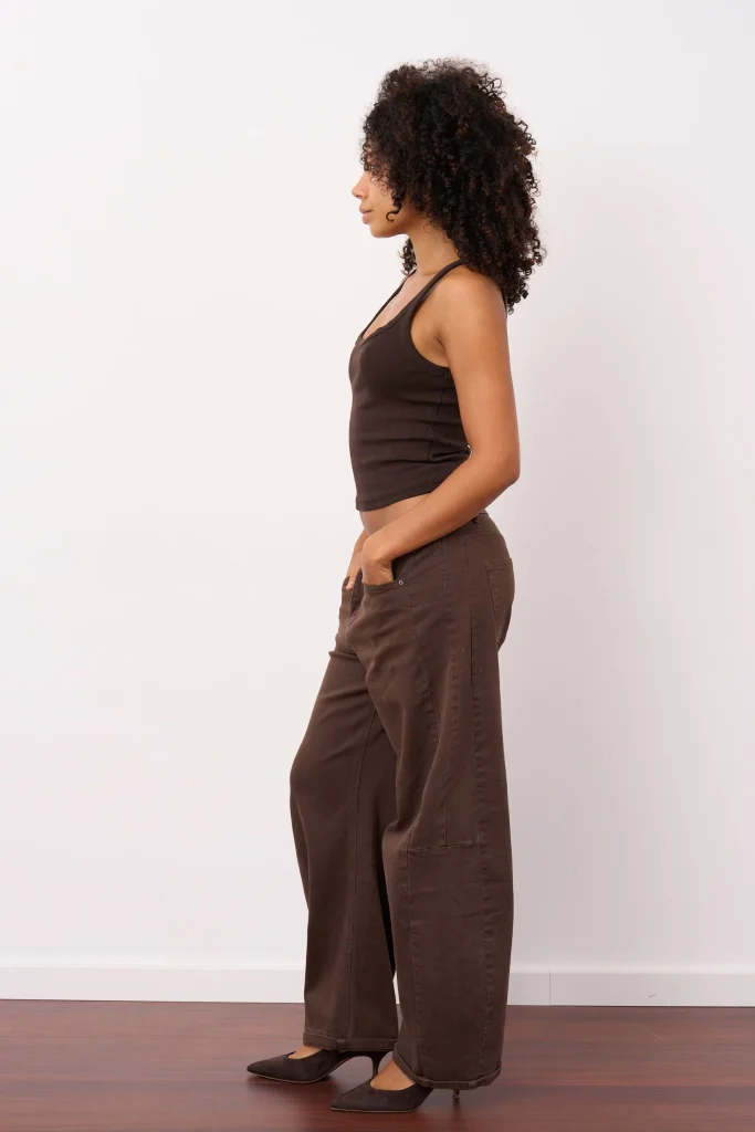 Frau im Profil mit braunem Top und weiter Hose
