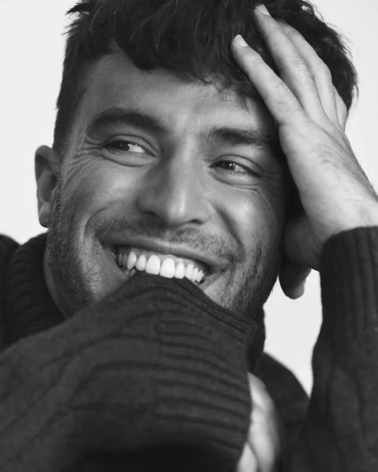 Smiling man resting hand on his head