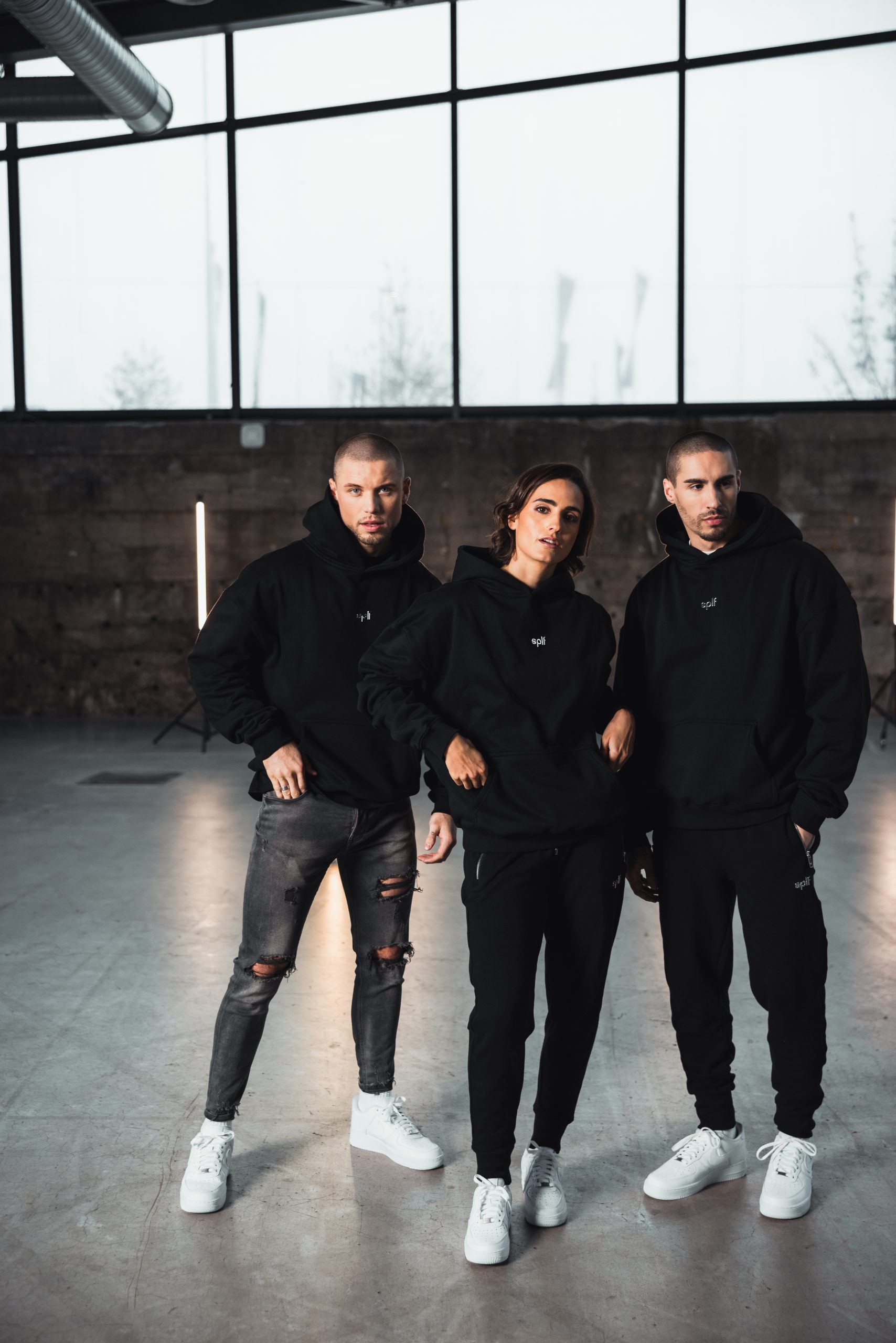 Drei Models in schwarzen Hoodies im Loft